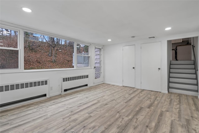 interior space with light hardwood / wood-style flooring and radiator heating unit