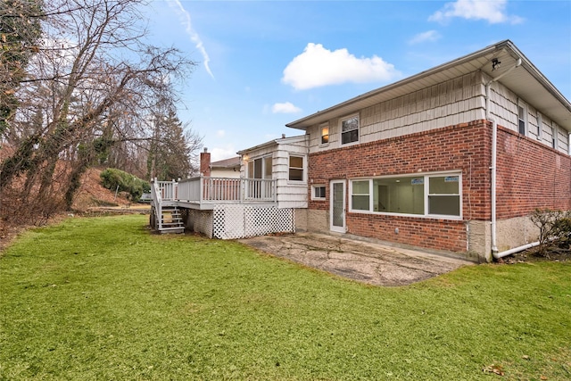 back of house featuring a wooden deck and a yard