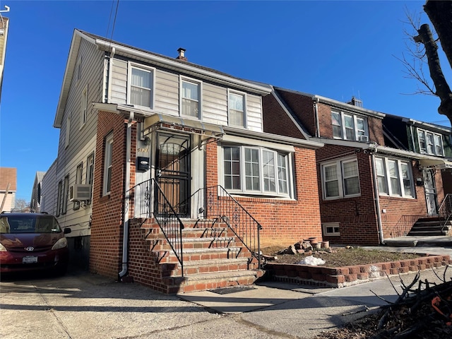 view of front of house with brick siding and cooling unit