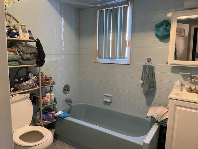 bathroom featuring shower / bathing tub combination, vanity, toilet, and tile walls