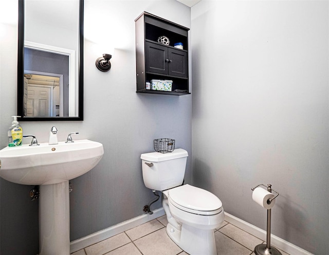 bathroom featuring toilet and tile patterned flooring