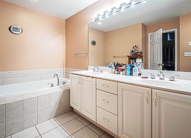 bathroom featuring vanity, tiled bath, and tile patterned floors