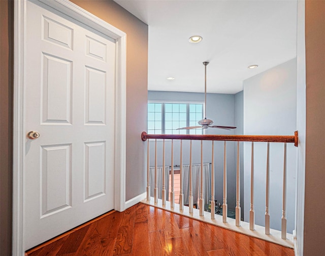 hallway with hardwood / wood-style floors