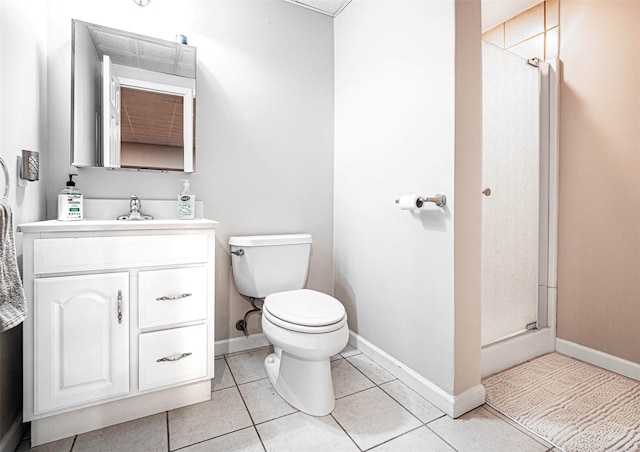 bathroom with vanity, toilet, tile patterned floors, and walk in shower