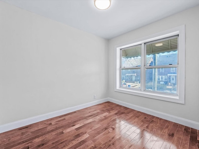 spare room with wood-type flooring