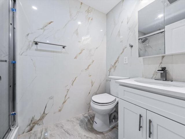 bathroom featuring vanity, toilet, tile walls, and a shower with shower door