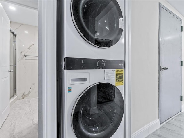 washroom with stacked washing maching and dryer