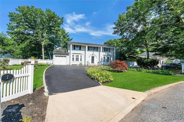 view of front of property with a garage and a front lawn