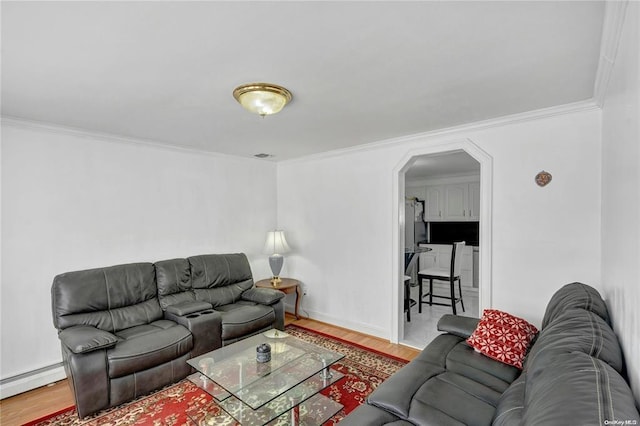 living room featuring baseboard heating, crown molding, and hardwood / wood-style floors