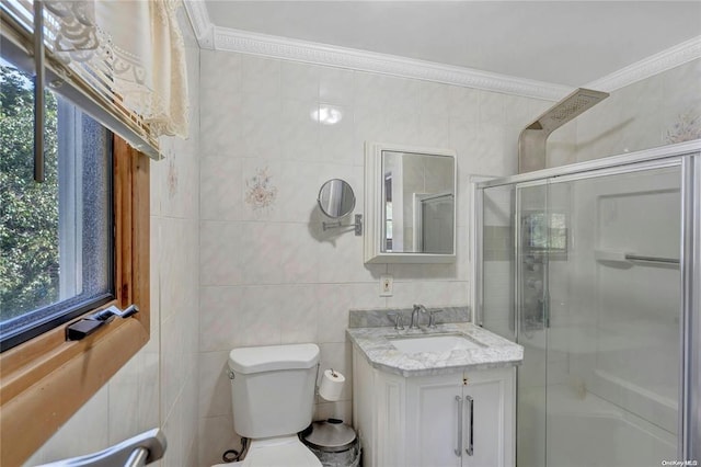 bathroom featuring vanity, ornamental molding, a shower with door, and toilet