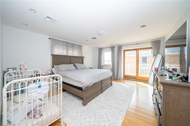 bedroom with access to exterior and light wood-type flooring