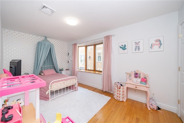 bedroom with hardwood / wood-style flooring