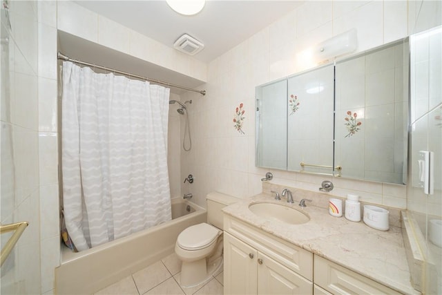 full bathroom with tile walls, tile patterned flooring, vanity, shower / bath combination with curtain, and toilet