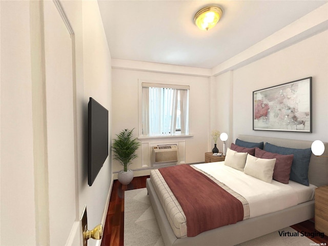 bedroom featuring hardwood / wood-style flooring and a wall unit AC