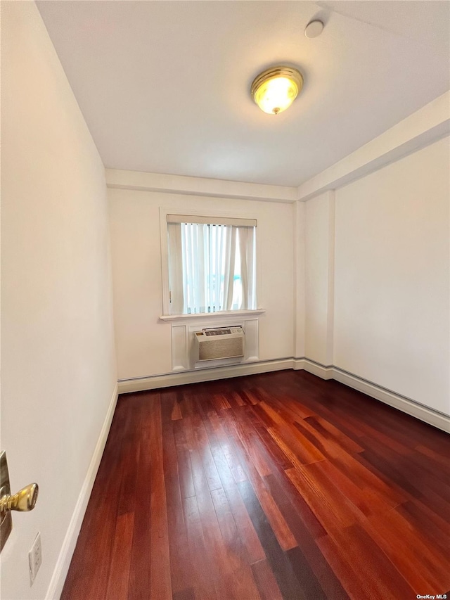 unfurnished room featuring dark hardwood / wood-style floors and a wall mounted AC