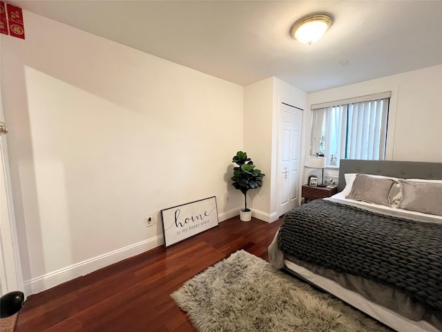 bedroom with baseboards and wood finished floors