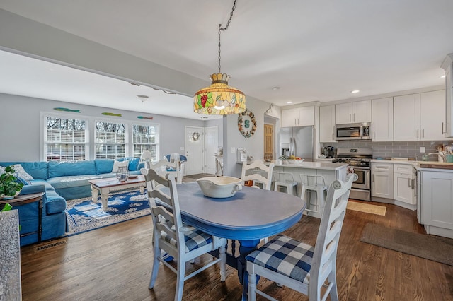 dining area with dark hardwood / wood-style floors