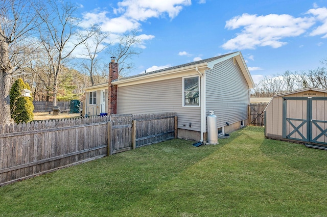 rear view of house featuring a yard and a shed