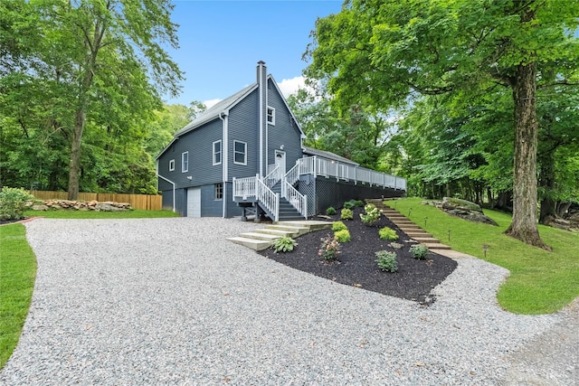 exterior space with a wooden deck, a garage, and a yard