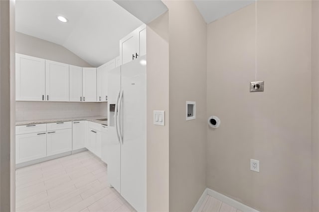 washroom with cabinets, washer hookup, and hookup for an electric dryer