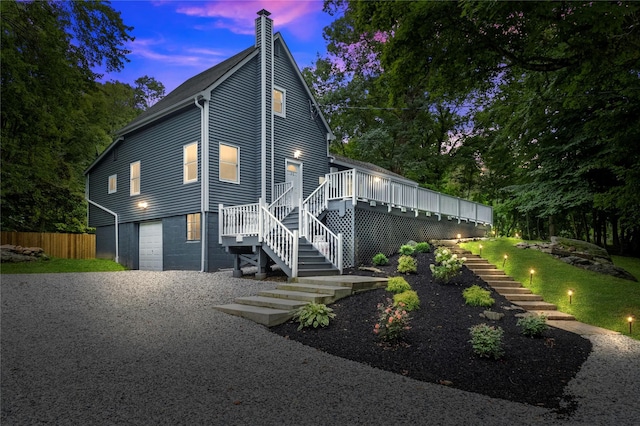 exterior space with a garage and a deck