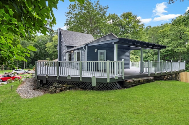 rear view of house with a lawn and a deck