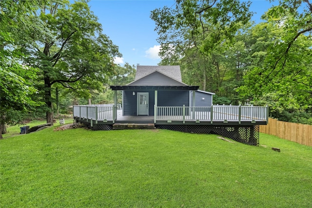 back of house with a wooden deck and a yard