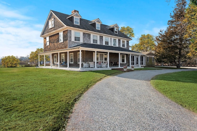 view of front of home featuring covered porch and a front lawn