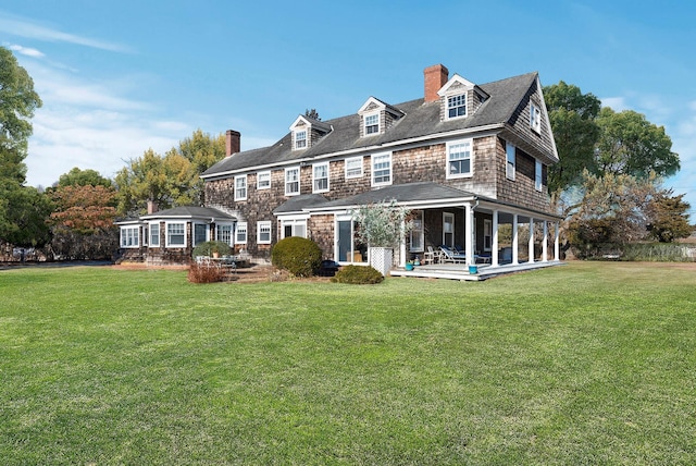 back of house with a patio and a yard