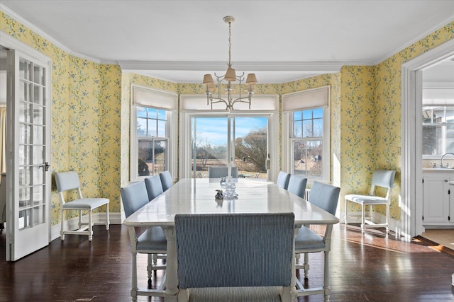 dining room featuring dark hardwood / wood-style flooring, a notable chandelier, ornamental molding, and sink