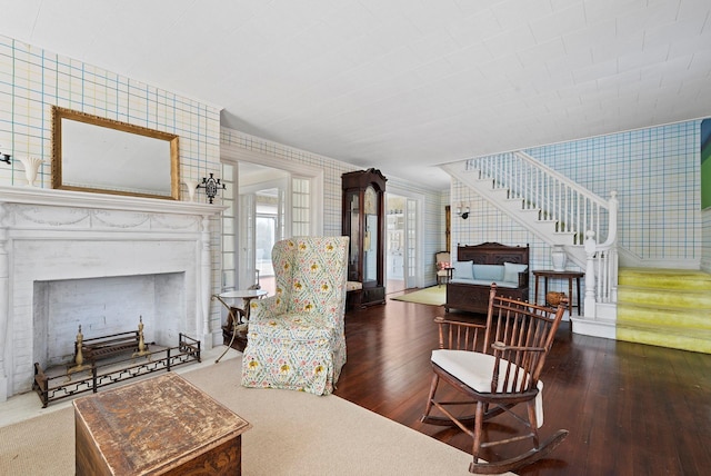 living room with hardwood / wood-style floors and tile walls