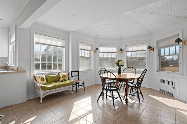 sunroom / solarium featuring radiator and sink