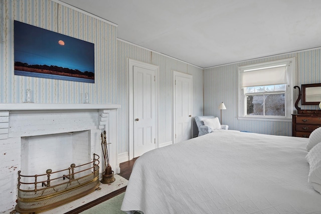 bedroom with wood-type flooring and a fireplace