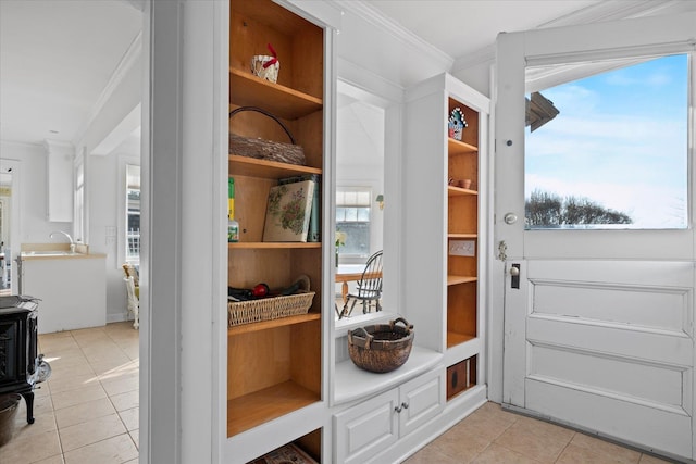 mudroom featuring crown molding and light tile patterned floors