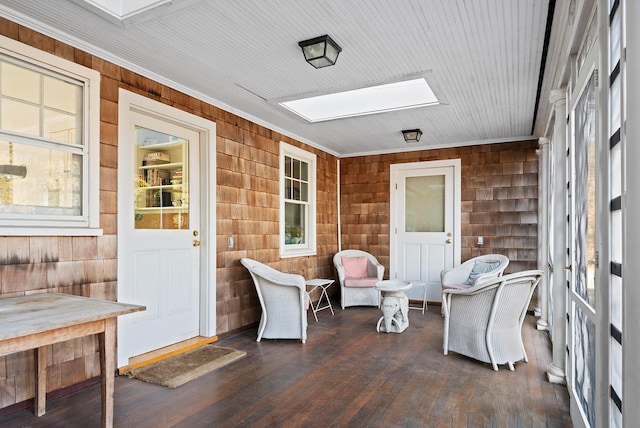 sunroom / solarium with plenty of natural light and a skylight