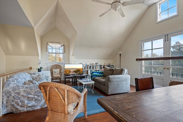 living room featuring vaulted ceiling, a wealth of natural light, and french doors