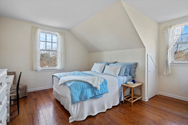 bedroom with lofted ceiling, dark hardwood / wood-style flooring, and multiple windows