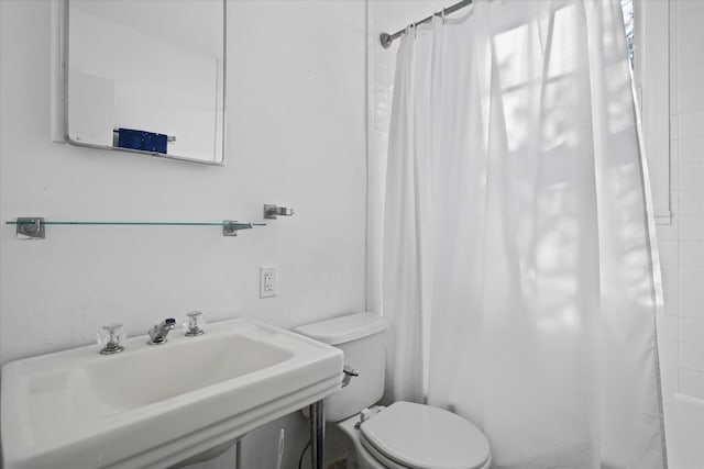 full bathroom with sink, shower / bathtub combination with curtain, and toilet