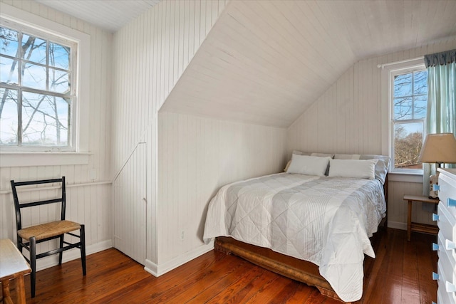 bedroom with dark hardwood / wood-style flooring and vaulted ceiling