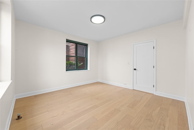 spare room with light hardwood / wood-style flooring