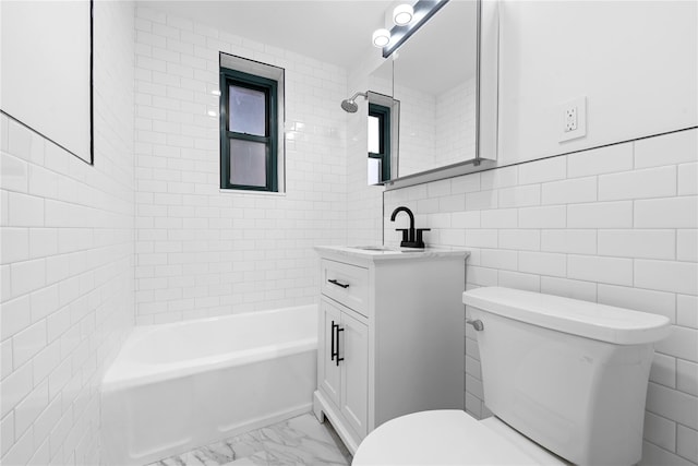 full bathroom featuring vanity, toilet, tiled shower / bath combo, and tile walls