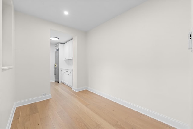 unfurnished room with light wood-type flooring