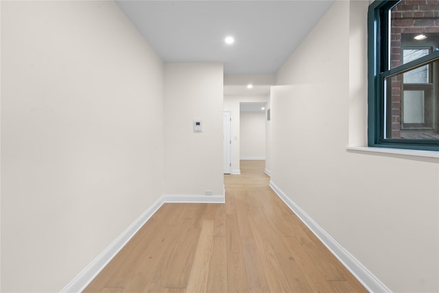 hallway with light hardwood / wood-style floors