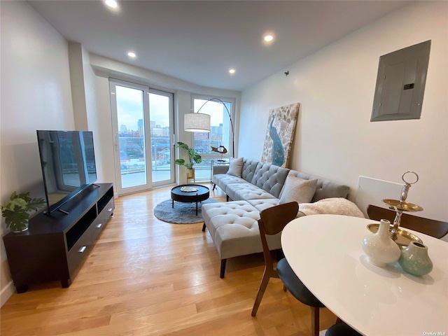 living room featuring electric panel and light wood-type flooring