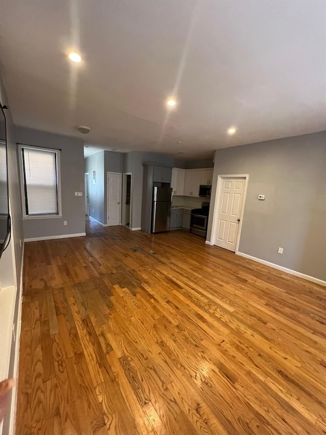 unfurnished living room with light hardwood / wood-style flooring