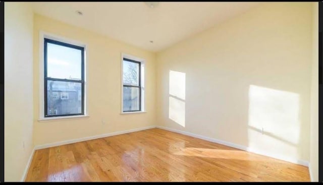 unfurnished room with light hardwood / wood-style floors