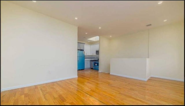 spare room featuring light hardwood / wood-style flooring