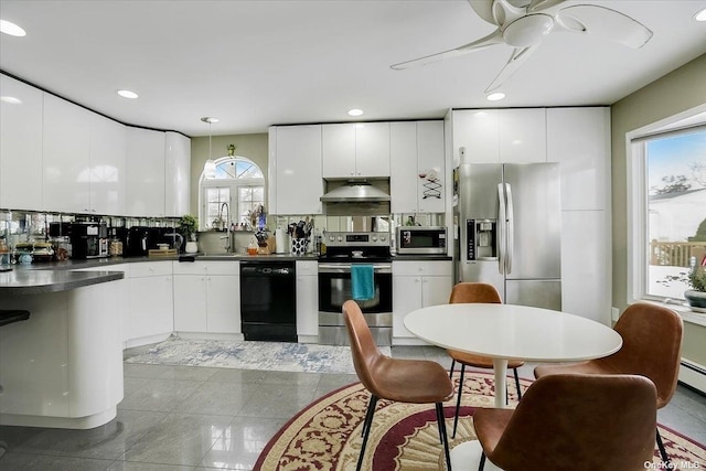 kitchen with white cabinetry, appliances with stainless steel finishes, decorative light fixtures, and decorative backsplash