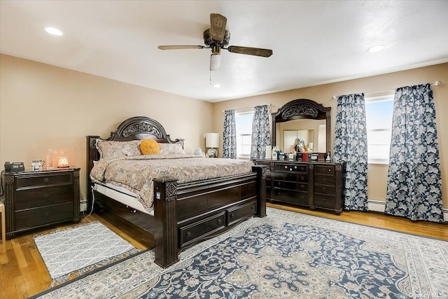 bedroom with light hardwood / wood-style flooring and ceiling fan