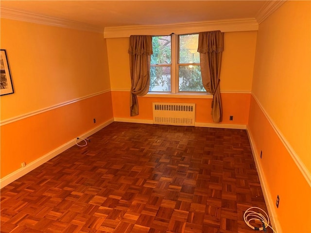 unfurnished room with ornamental molding, radiator heating unit, and dark parquet floors